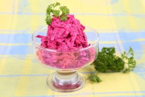 Beet salad with sour cream and garlic on the table